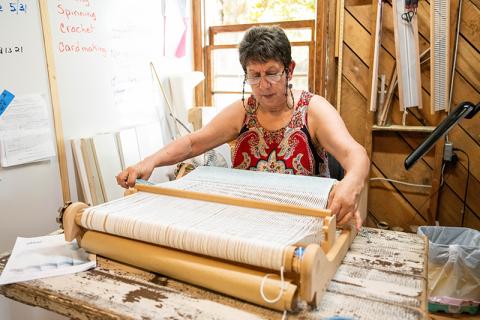 Gene Pease weaves on a heddle loom in the new AppalachianGap studio near the Art-Ful Barn’s new location off Ga. 17 in Clarkesville. ZACH TAYLOR/Staff