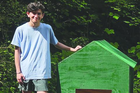 David Quintal poses with one the dog houses he built with a team of volunteers for his Eagle service project. SUBMITTED