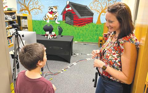 Ollie Osborne talks with media specialist Annabelle Wiley about Level Grove Elementary’s Bulldog Broadcast during last year’s open house at the school. (File)