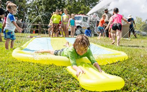 Alex McSherry smiles as he goes just off the edge of the slip-n-slide at the Summer Splashdown event at Tallulah Gorge State Park on Saturday. (Zach Taylor/Staff)