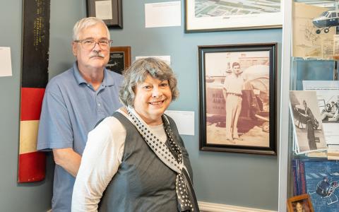 Julie and Don Fraser stand beside a photo of Hal Symes at the Habersham County Airport. (Zach Taylor/Staff)