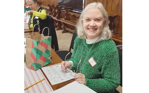 Leslie Rohrabacher enjoys serving in the Tomochichi Chapter of the Daughters of the American Revolution. Above, she works with the chapter to stuff gift bags for veterans last December. (Submitted)