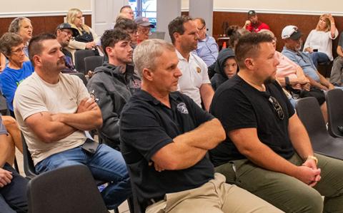 A crowd of over 30 people gathered in the Baldwin Police Department to participate in the June Baldwin City Council meeting, where the council approved a budget with a deficit of $429,030.77 to be offset by property tax increase. (Hannah Caudell/Staff)