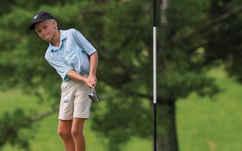 Camper Fletcher Lunsford hits the ball toward the hole during session four of the golf camp at Apple Mountain Golf Club & Resort on Wednesday, July 2. (Landen Todd/Staff)