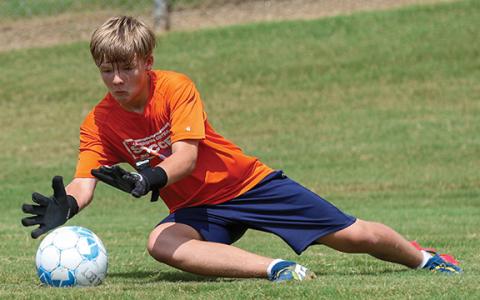 Camper Micah Merck practices saving the ball during the Select Team Academy at Habersham Central High School on Tuesday, July 22. (Landen Todd/Staff)