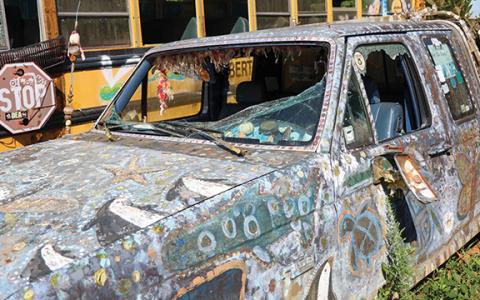 The front windshield and door windows of a vehicle in the School Bus Graveyard has been damaged after a vandalism attempt last Wednesday. (Landen Todd/Staff)