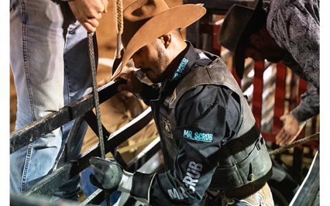 Austin Beaty of Glade Hill, Va., gets his hand tacked up with rosin before locking his hands into a rope on a bull during last year’s rodeo. (Zach Taylor/Staff)