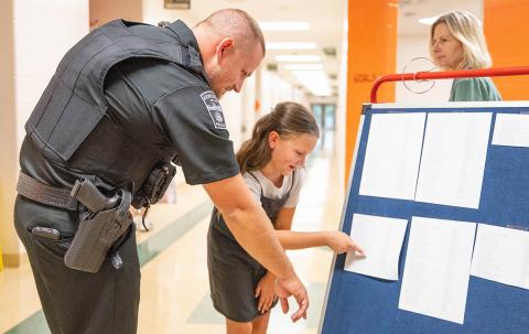 Demorest Elementary’s newest school resource officer (SRO), Joe Chastain, looks at classes with Rosemary Couch at the school’s open house on Wednesday. Chastain begins his first day of SRO duties today under the direction of Demorest Assistant Chief of Police James Minutello. (Zach Taylor/Staff)