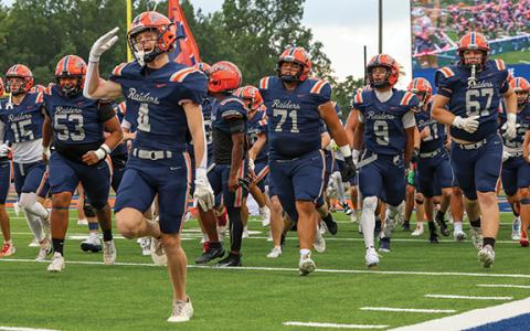 The Raiders run onto the field during the game between Flowery Branch and Habersham Central at Raider Stadium on Friday, Aug. 22.  (Landen Todd)