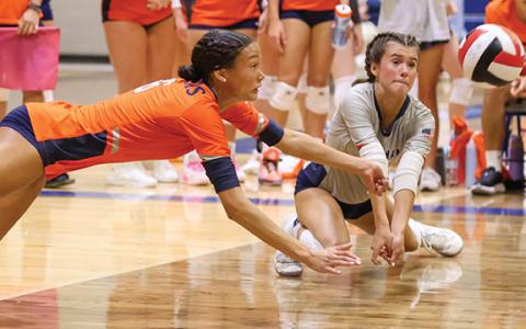 Habersham Central senior Kenzie King (12) and sophomore Sydney Patterson (2) go after the ball during a volleyball match at Banks County High School on Tuesday, Aug. 19. The Lady Raiders beat the Red Raiders (25-14, 20-25, 15-11) and beat the Leopards (27-25, 25-22). (Landon Todd/Staff)