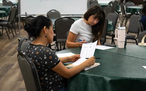 Volunteer April Matson (right) prepares to help a returning student for the Volunteers for Literacy Adult English Language Acquisition program. (Hannah Caudell/Staff)