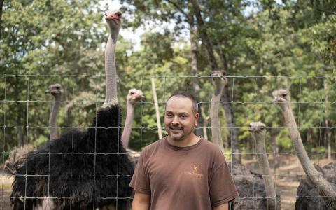 Georgia Ostrich Farm owner Stefan Kuehnert stands in front of his breeding pair pen at the Turnerville location. (Zach Taylor/Staff)