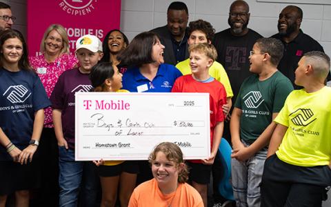 Members of the Tim Lee Boys and Girls Club, the organization’s leadership team, and representatives from T-Mobile stand around the giant $50,000 T-Mobile Hometown Grant check, which helped the Boys and Girls Club of Lanier to purchase much-needed electronics for both the Habersham club and their satellite locations in the school system. (Hannah Caudell/Staff)