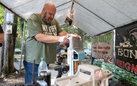 Dana Westbrook works on his truck before a Tough Truck Challenge at The BoneYard. (Zach Taylor/Staff)