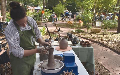 Laurel Camp molds a small tea cup using a pottery technique called throwing off the hump. (Samantha Sinclair/Staff)