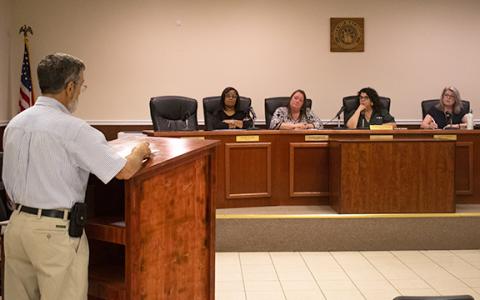 John Smith, a Baldwin resident on the Banks County side of the city, spoke before four council members to oppose the millage rate during one of Baldwin’s public hearings on Thursday. He believes something has gone awry in Baldwin after the revenue from millage rate increases have more than doubled since 2022. (Hannah Caudell/Staff)