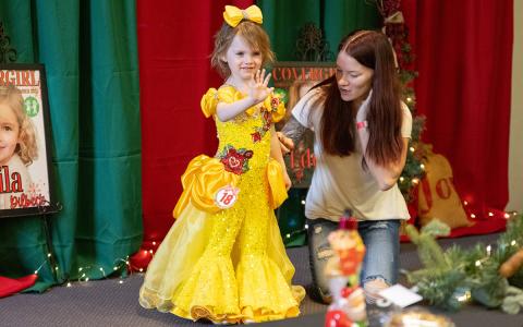 Braylin Winkles waves to the judges and the crowd during the princess dress portion of the pageant. (Zach Taylor/Staff)