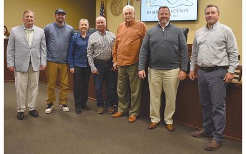 Habersham County Board of Commissioners — Bruce Harkness, Jimmy Tench, Kelly Woodall and Ty Akins —recognizes Farm-City Week with Habersham County Farm Bureau representatives (center) Jared Brooks, Cheryl Kowalsky and Jimmy Kowalsky. (Samantha Sinclair/Staff)