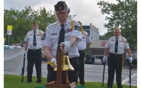 Dr. Ed Hendricks tolls the bell in memory of those who died in wars at the Memorial Day ceremony in Clarkesville this year. (Samantha Sinclair/Staff)