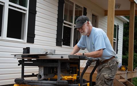 Habitat for Humanity volunteer John Ott cuts flooring to fit into one of the new Habitat homes on the Clarkesville property. Habitat for Humanity of Northeast Georgia is one of the housing nonprofits affected by the government shutdown, which ended Wednesday evening. (Hannah Caudell/Staff)