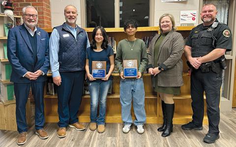 John Fair of Peachstate Federal Credit Union, Scott Roland of Peachstate Federal Credit Union, Nicole Dover of Habersham EMC and Habersham Sheriff Deputy Aaron Autry honor Wilbanks Middle School’s REACH Scholars Jasmine Solorzano and Daniel Martinez. (Submitted)