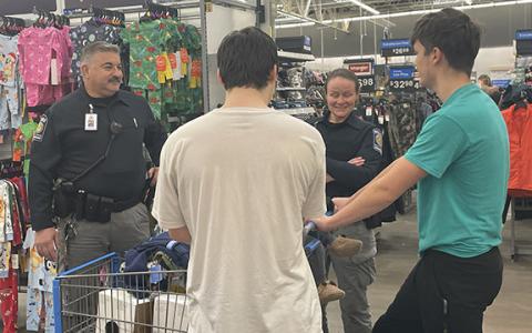 Habersham County School System Police Department Chief Murray Kogod (far left) and School Resource Officer Victoria Hopper (middle right) converse with a couple of students while buying them both Christmas presents and other necessities they may need over the holidays. (Hannah Caudell/Staff)