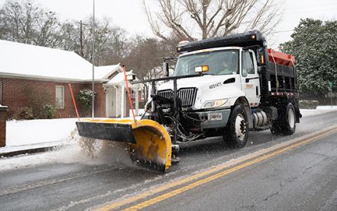 A Georgia Department of Transportation plow truck scrapes ice off of Washington Street in Clarkesville during last year’s snowstorm. (Zach Taylor/Staff)