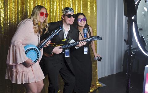 Jacey Vickery, Robby Edge and Anna Anastasio enjoy playing around in the photo booth. (Samantha Sinclair/Staff)