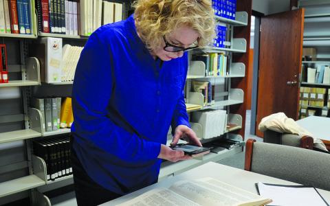 Susan Gwaltney finds Abraham Helton’s name in Index to Heads of Families 1830 Census of Georgia which she found on the shelves of the William H. Raper Heritage Room at the Clarkesville Public Library. (Samantha Sinclair/Staff)
