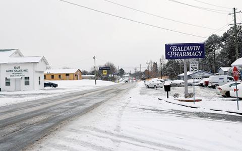 The intersection of Willingham Avenue and Manor Place Drive in Baldwin shows the difference in road conditions Saturday afternoon. (Landen Todd/Staff)