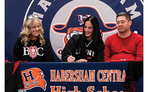 Raegan Turner, Habersham Central senior Eden Turner and Ken Turner sit together during the signing ceremony. (Submitted)