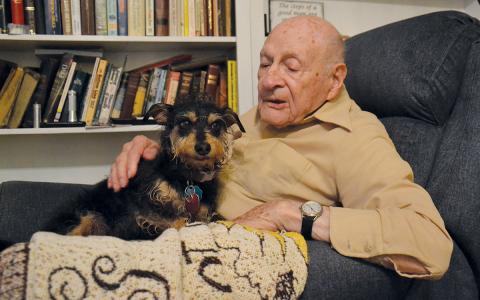 The Rev. Billy Burrell pets Elvis Andrew as he talks about his life. (Samantha Sinclair/Staff)