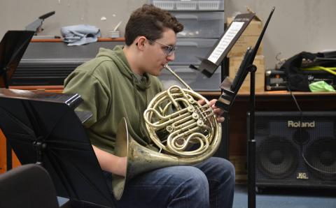 Christian Moore practices playing the French horn during band class at Habersham Central High School on Wednesday. (Samantha Sinclair/Staff)