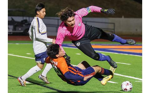 Habersham Central Junior Josue Rendon (8) collides with the Wildcat’s goalkeeper during a soccer match between Habersham Central and Apalachee at Raider Stadium on Friday, Feb. 27. (Landen Todd/Staff)
