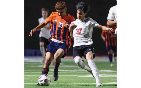 Habersham Central sophomore Arnol Hernandez (23) fights for the ball during a soccer match between Winder-Barrow and Habersham Central at Raider Stadium on Friday, March 20. (Landen Todd/Staff)
