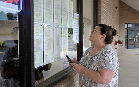 Rena Thompson of Demorest looks at the sample ballots posted on the window of the Habersham County Elections and Voter Registration Office before heading in to vote Monday morning. (Samantha Sinclair/Staff)
