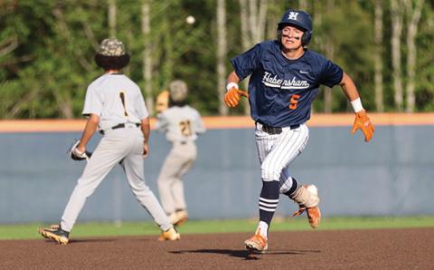 Habersham Central senior outfielder Maverick Chitwood (5) beats out the throw during a baseball game between Alcovy and Habersham Central. (Landen Todd/Staff)
