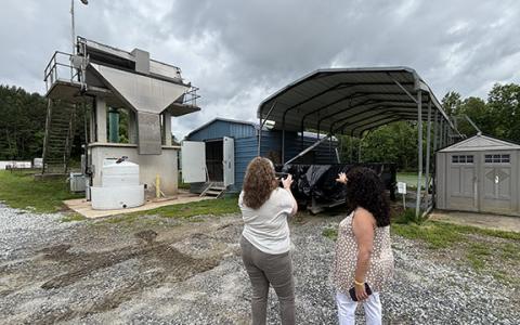 Baldwin’s Georgia Mountain Regional Commission Representative Laurin Yoder takes a picture of Baldwin’s wastewater treatment plant, while former mayor Stephanie Almagno accompanies her. Baldwin recently awarded the plant’s solids handling building project to Willow Dell LLC for $1.278 million. (Submitted)