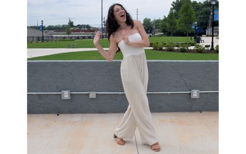 Amber Watson of Smudged Academy practices dance moves in Donald Anderson Park where she and Sheila Humphrey will lead a 100 Years of Dance warm-up Saturday morning. (Samantha Sinclair/Staff)
