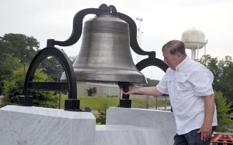 Commission Chairman Bruce Harkness was surprised with the opportunity to ring the old courthouse bell after its unveiling. Plans are to set the mechanism so the bell can not be rung and damaged. (Samantha Sinclair/Staff)
