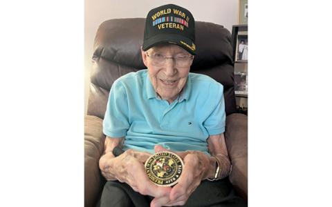 Capt. Ken Schubring Sr. holds the challenge coin President Donald Trump presented to him on July Fourth. (Submitted)