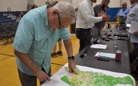 Jimmy Dean looks over the proposed zoning map for the Unified Development Ordinance following the town hall on June 4. (Samantha Sinclair/Staff)