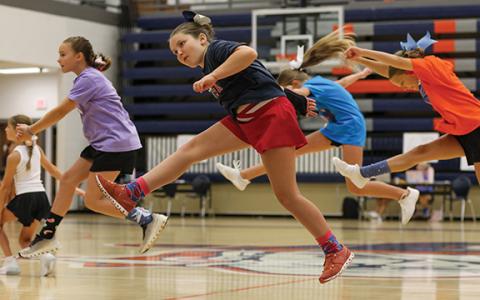 CHS cheer camper Everly Nicolson runs during a game of Duck, Duck, Goose during the cheer camp at the Raider Gymnasium on Wednesday, July 8. (Landen Todd/Staff)