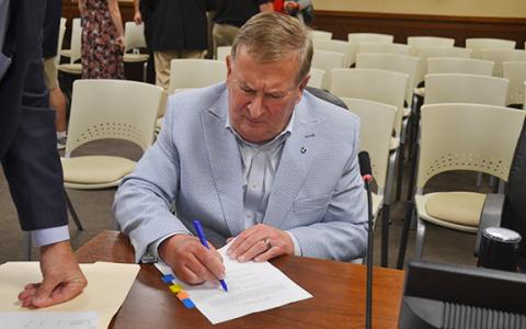 Habersham County Commission Chairman Bruce Harkness signs general obligation bond purchase documents. (Samantha Sinclair/Staff)