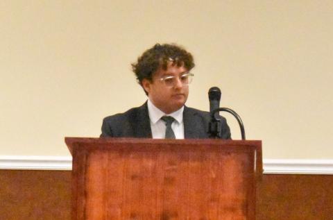 Baldwin City Attorney Sammy Tomasello stands before council to explain the risks associated with moving forward with a Cook Construction petition vote Tuesday night. (Hannah Caudell/Staff)