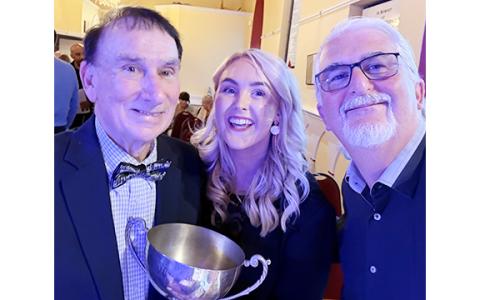 Don Gnecco, Saoirse Scully and Pat Marnane take a photo with the Perpetual Cup after an award-winning performance at the 2026 International Song of Peace contest. (Submitted)