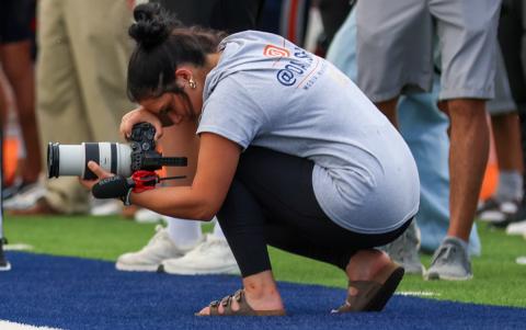 Habersham Central High School senior Oaklee Jackson tries to get a different angle for a photo during a Raider Football game. (Landen Todd/Staff)