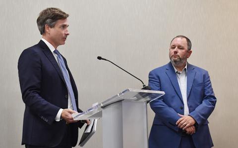 Andrew Tritt (left), managing director at brokerage and investment banking firm Stifel, Nicolaus and Company Inc., thanks the board for working with the company as they prepare to vote for a bond sale agreement for the playground project while Superintendent Patrick Franklin looks on. (Hannah Caudell/Staff)