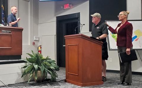 Councilman Donnie Bennett approaches the podium in an attempt to get Councilman Jimmy Davis, who is speaking at the podium, to conclude his message as Sherri McCullough tells council that Davis will continue to speak. (Samantha Sinclair/Staff)