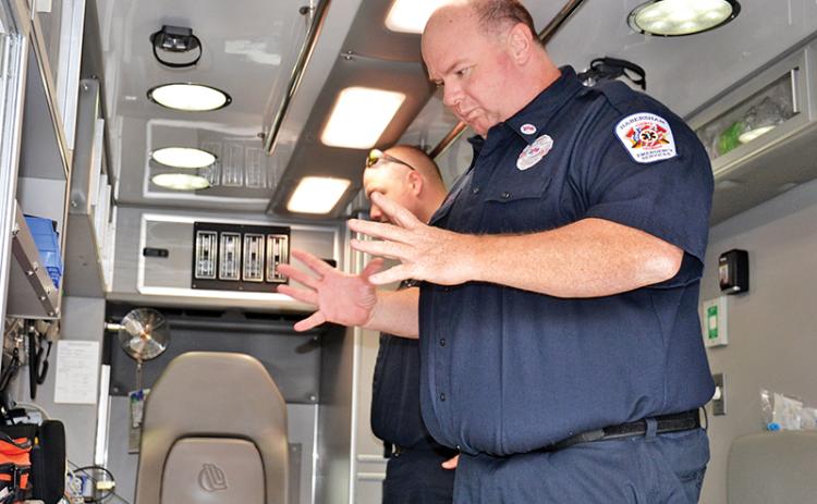 Paramedics Greg Ramey, right, and Cody Crocker talk Friday about some advances Habersham County has made over the years with its emergency medical strategies over the years.